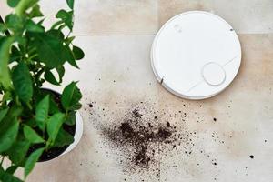 Robot vacuum cleaner cleans dirt on floor. Smart home concept photo