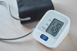 Digital blood pressure monitor on the table, closeup. Helathcare and medical concept photo