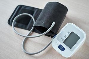 Digital blood pressure monitor on the table, closeup. Helathcare and medical concept photo