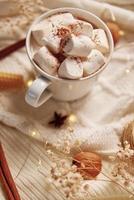 Hot chocolate with marshmallow and christmas decorations. Winter cozy home photo