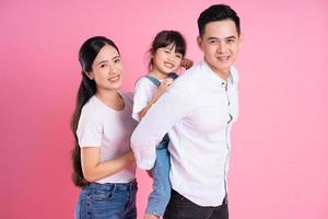 young asian family image isolated on pink background photo