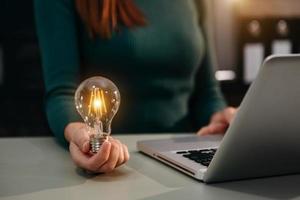 business hand showing creative business strategy with light bulb concept photo