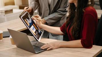 The business team analyzes revenue charts and graphs with laptop and tablet.Business analysis and strategic ideas. at office photo