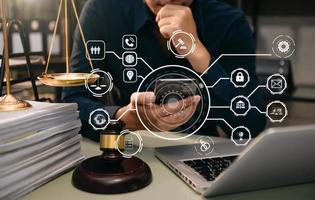 justice and law concept.Male judge in a courtroom  the gavel, working with smart phone and laptop and digital tablet computer with VR icon photo