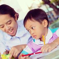 A mother in a nursing uniform is teaching her son homework. photo