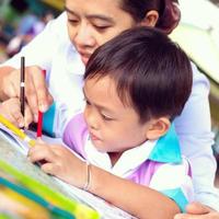 A mother in a nursing uniform is teaching her son homework. photo