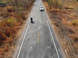 Arid yellow forest, The road in the forest was filled with trees blackened by forest fires. photo