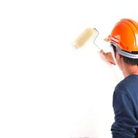 worker paints a wall roller for painting photo