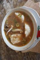 Coto Makassar food from Indonesia with some meat and lontong photo