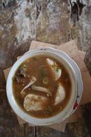 Coto Makassar food from Indonesia with some meat and lontong photo