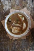 Coto Makassar food from Indonesia with some meat and lontong photo