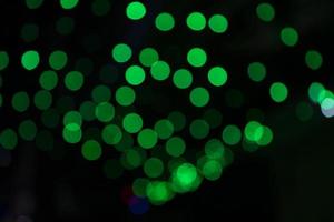Green Defocus Abstract bokeh light effects on the night black background texture photo