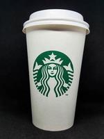 West Java, Indonesia in October 2022. A white paper cup with the starbuck logo, is used for hot drinks. photo