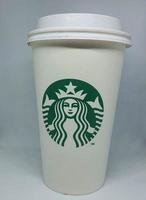 West Java, Indonesia in October 2022. A white paper cup with the starbuck logo, is used for hot drinks. photo