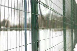 Green fence grille. Fence details. photo