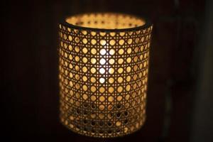 Lamp with wooden lampshade. Beautiful lamp in dark. photo