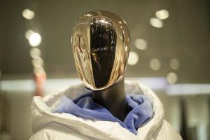 Golden mask on face of mannequin. Details of style and fashion. Mannequin in clothing store. photo