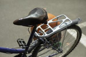 Old bike seat. Retro bike on street. Transport of bygone era. photo