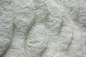 Texture is white. Details of sculpture. Whitewashed surface. Background is made of clumps. photo