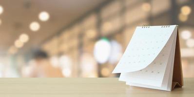 desk calendar on table with blurred bokeh background appointment and business meeting concept photo