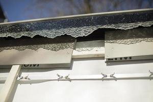 Broken glass of advertising construction. Shards of glass in billboard panel. photo