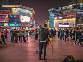 Changsha.China-17 October 2018.Unacquainted street performers singing at huangxing walking street in Changsha city China.changsha is the capital and most populous city of Hunan province in china photo