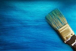 A brush on a blue nacreous color painted background. Abstract  background. photo