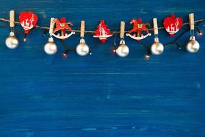 Christmas decorations and Christmas lights on the blue wooden background, top view. photo
