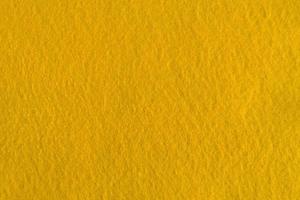 textura natural de fieltro amarillo para el fondo. foto
