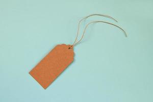 Brown blank paper price tag or label set on the blue background, top view. photo