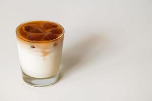 A glass of milk with coffee ice on the white background. photo