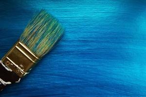 A brush on a blue nacreous color painted background. Abstract  background. photo