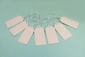 White blank paper price tags or labels set on the blue background. photo