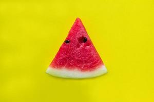 Red watermelon on yellow background. photo