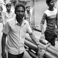 Old Delhi, India, April 15, 2022 - Unidentified group of men walking the streets of Old Delhi, Street Photography of Chandni Chowk market of Old Delhi during morning time, Old Delhi Street Photography photo