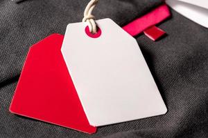 A closeup shot of white red clothing tags on a string with copy space photo