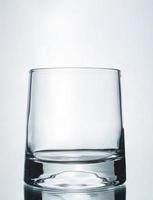 A vertical shot of an empty glass on a grey background photo