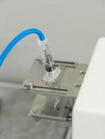 A closeup of the production and testing of medical syringes and droppers photo