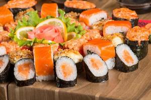 A closeup shot of a sushi set on a wooden plate photo