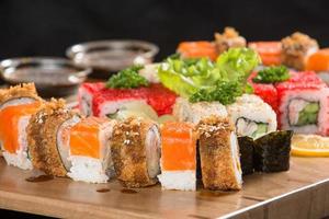 A closeup shot of a sushi set on a wooden plate photo