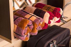 A closeup shot of folded plaid bamboo towels on a bathroom shelf photo