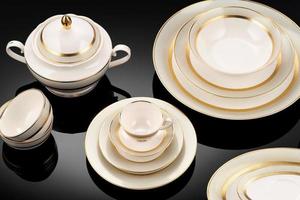 A luxury tableware set on black reflective surface photo