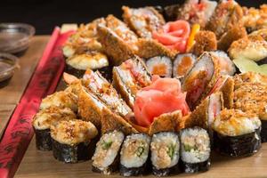 A closeup shot of a sushi set on a wooden plate photo