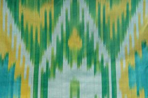 An illustrated abstract design on a green and blue striped background photo