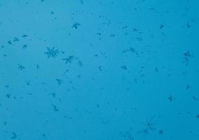 snowflakes on a blue background. closeup snow texture, natural Christmas bacground photo