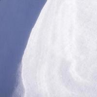 Snow and wind combined formed snow waves in a agricultural environment. photo