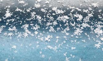 snowflakes on a blue background. closeup snow texture, natural Christmas bacground photo