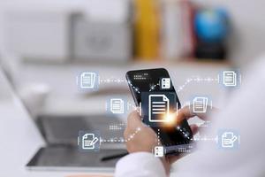 Businessman working with electronics document icons, E-document management, online documentation database, paperless office concept photo