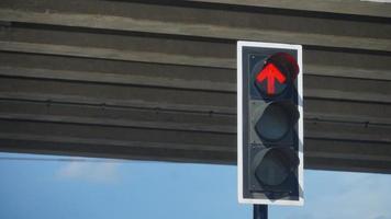 Red traffic light. Indicates that the direct way to stop. background image is a level bridge made of concrete. photo