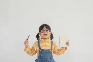 Portrait of funny smiling little girl child wearing glasses photo